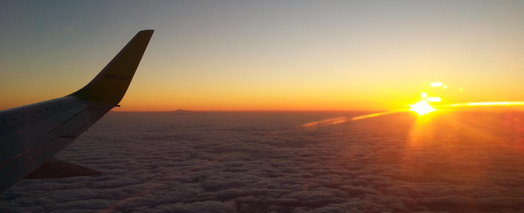 Business aviation aircraft in flight above clouds, illustrating market trends and operational planning in business aviation