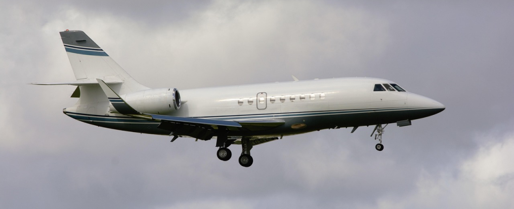 Business jet aircraft in flight with landing gear deployed